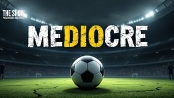 A soccer ball sits on a green field in a brightly lit stadium. Above, the word "MEDIOCRE" appears in bold, cracked letters, with the letters "DIO" highlighted in yellow. The background shows blurred rows of stadium seating and spotlights.
