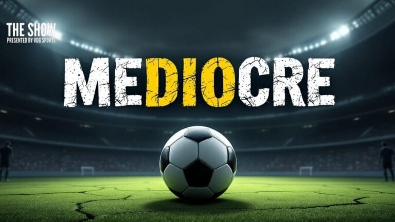A soccer ball sits on a green field in a brightly lit stadium. Above, the word "MEDIOCRE" appears in bold, cracked letters, with the letters "DIO" highlighted in yellow. The background shows blurred rows of stadium seating and spotlights.