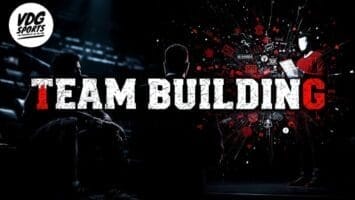 A dark room with three people: two seated in shadow and one standing, illuminated and holding a tablet, surrounded by red digital icons like those seen on NBA DRAFT night. Bold white and red “TEAM BUILDING” text centers the scene. VDG Sports logo is top left.