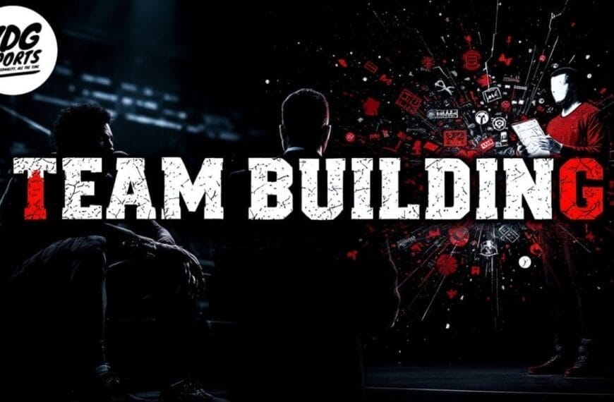 A dark room with three people: two seated in shadow and one standing, illuminated and holding a tablet, surrounded by red digital icons like those seen on NBA DRAFT night. Bold white and red “TEAM BUILDING” text centers the scene. VDG Sports logo is top left.