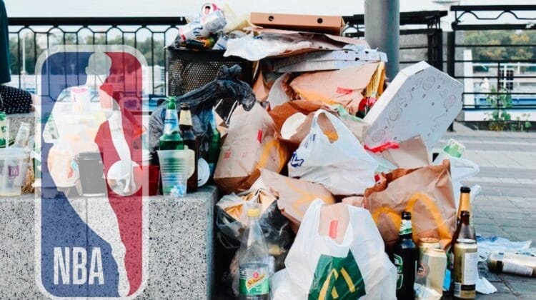 A pile of trash including bags, boxes, and bottles cluttered the sidewalk, with the NBA logo prominently displayed on the left side, reminiscent of the league's notorious trash talkers stirring up a scene.
