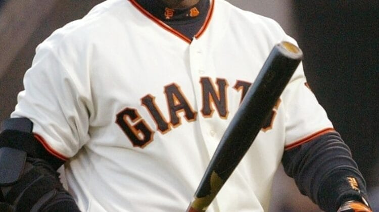 Barry Bonds, a baseball player, is gripping a bat.