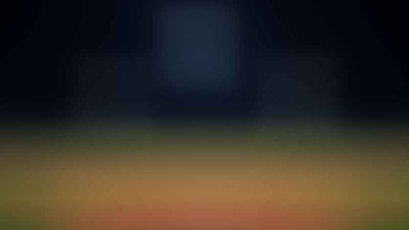 A baseball field is empty, with a lone spotlight shining down.