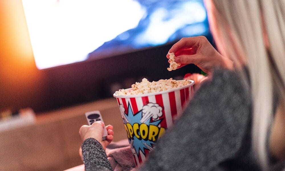 With popcorn in hand and a remote at the ready, they're enjoying a cozy evening watching NBA games unfold on the TV.