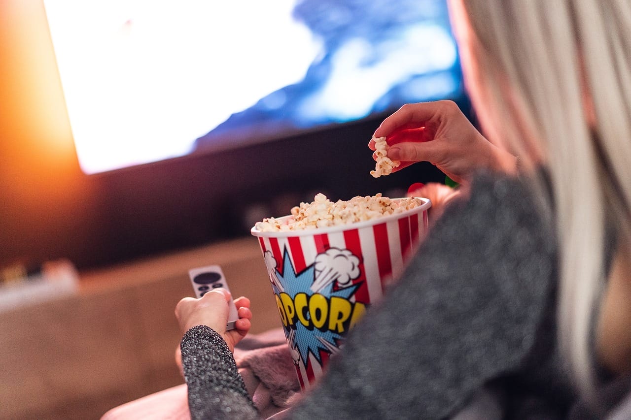 With popcorn in hand and a remote at the ready, they're enjoying a cozy evening watching NBA games unfold on the TV.