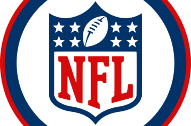 NFL logo with a football and stars on a shield, surrounded by red and blue circular borders, honoring the legacy of the greatest NFL players of all time.