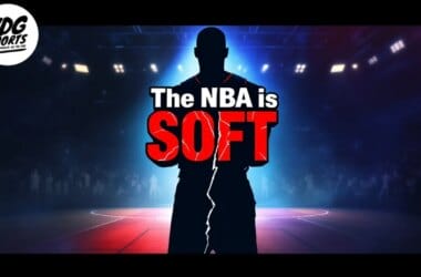 Silhouette of a basketball player standing on a court with text reading "The NBA is SOFT" in bold letters. The background shows a basketball arena with dim lighting. VDG Sports logo is in the top left corner.