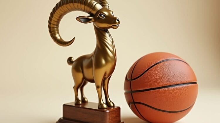 A shiny golden ram trophy with curled horns stands on a wooden base next to an orange basketball on a neutral beige background, symbolizing the GOAT of Basketball and celebrating excellence in sports achievement.