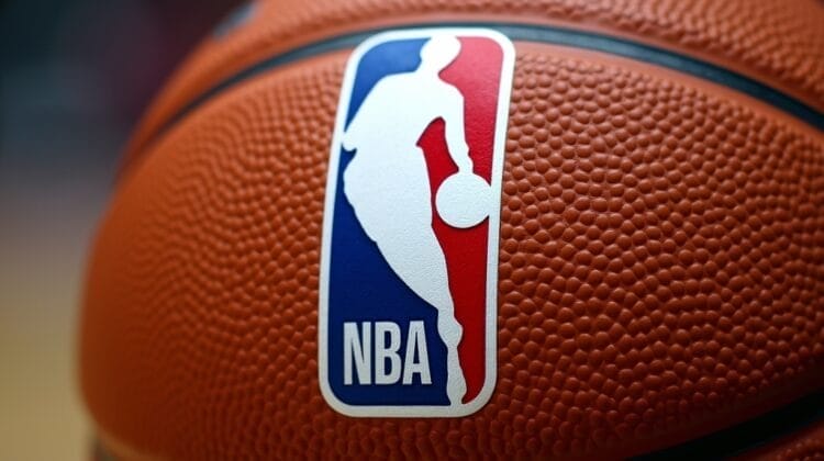 A close-up of a textured orange basketball featuring the official NBA logo, evoking the golden age of basketball. The sharp focus highlights the iconic ball while the background remains blurred for dramatic effect.