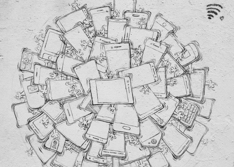 A mural shows a bomb made from clustered smartphones, with small people clinging to the phones. At the top, a bomb fuse is depicted; to the right are a Wi-Fi symbol and a heart—hinting at digital obsessions like why is ESPN losing viewers.